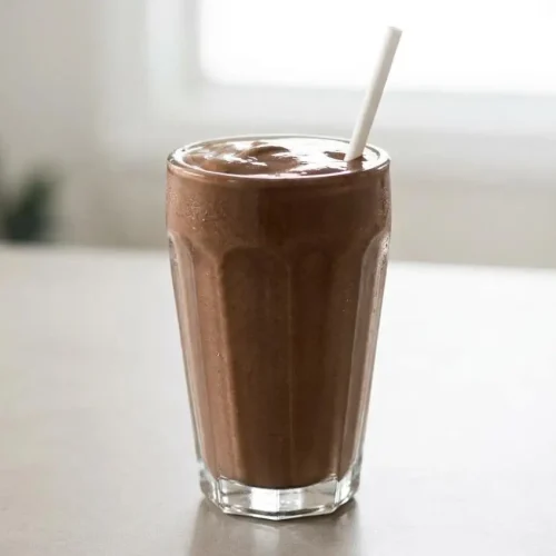 A thick and creamy Keto Chocolate Milkshake in a tall glass, with a smooth, glossy surface ready to drink.