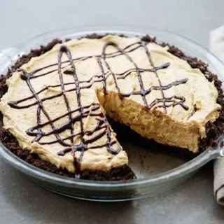 Keto peanut butter pie recipe with a silky mousse filling and dark cocoa almond crust.