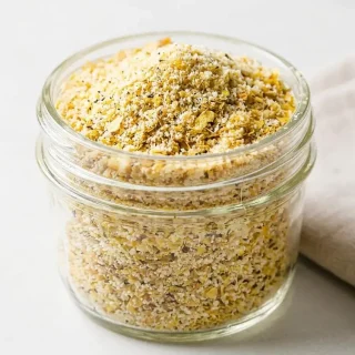Crispy golden keto bread crumbs coating with toasted almond and flaxseed texture.