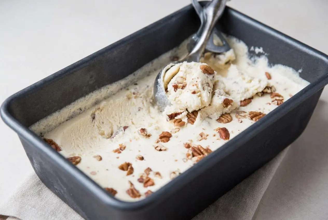 Scoops of velvety keto butter pecan ice cream with toasted buttery pecans and glossy custard texture.