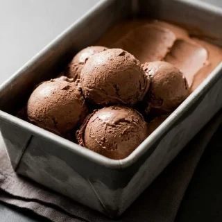 Velvety scoops of keto chocolate ice cream recipe with a rich, glossy cocoa custard texture.