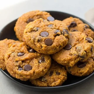 Chewy keto pumpkin chocolate chip cookies studded with melted dark chocolate and crunchy pecan pieces.
