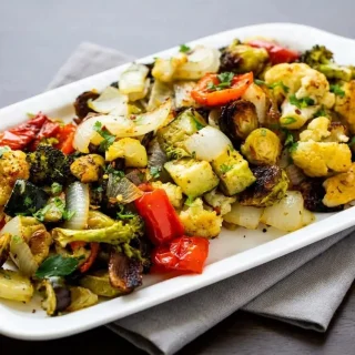 Tender keto roasted vegetables with caramelized golden brown edges and a light herb seasoning.