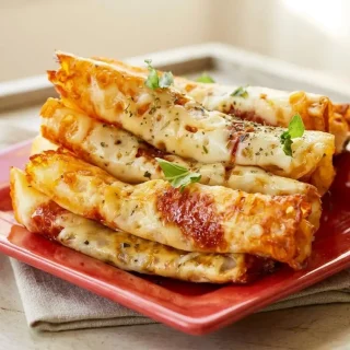 Crispy keto pizza roll ups baked to golden perfection with melted mozzarella and savory pepperoni.
