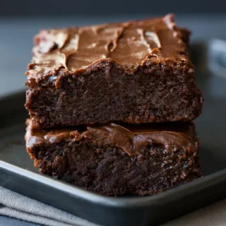 Freshly baked keto brownies with a delicate matte crust and rich, dense fudgy centers.