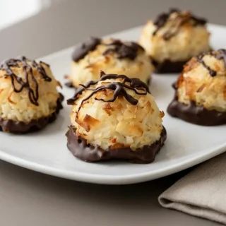 Golden baked keto coconut macaroons with lightly toasted tips and chewy shredded coconut centers.