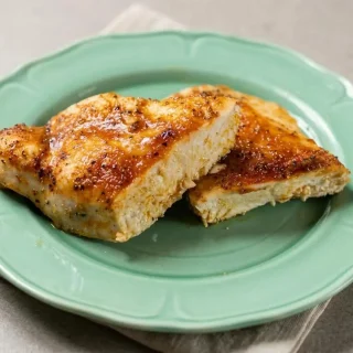 Keto baked chicken breast with a savory golden-brown smoked paprika crust and juicy sliced center.