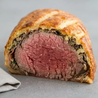 Keto beef wellington recipe featuring a golden crispy mozzarella almond flour crust and tender beef.