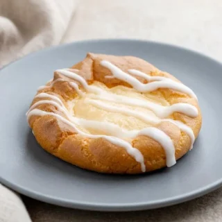 Golden keto cheese danish with a silky cream cheese center and sweet lemon drizzle.