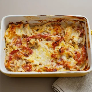 Keto chicken cordon bleu casserole baked to a bubbly, golden-brown finish with melted Swiss cheese.