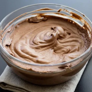 Silky keto chocolate mousse served with defined whipped ridges and a glossy finish.