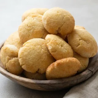 Golden keto coconut flour cookies with lightly browned edges and a tender buttery crumb.