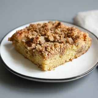 Keto coffee cake with bakery style pecan streusel topping and tender almond flour crumb.