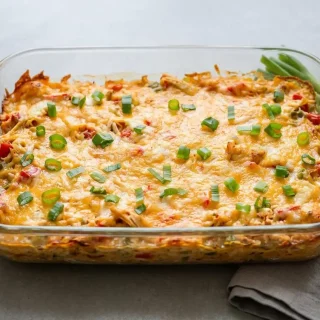 Baked keto king ranch casserole with bubbling golden Colby Jack cheese and creamy shredded chicken layers.