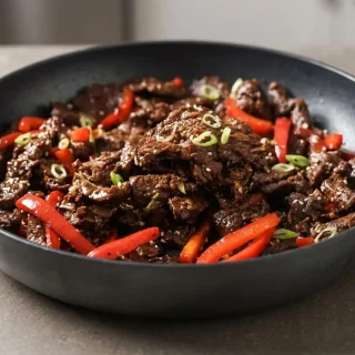 Keto mongolian beef recipe featuring tender seared steak strips coated in a glossy sweet-savory glaze.