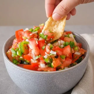 Keto pico de gallo recipe in a bowl with crisp diced tomatoes, fresh cilantro, onions, and jalapeños.