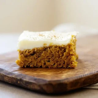 Keto pumpkin bars recipe square with plush cream cheese frosting and tender crumb.