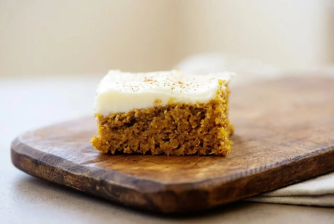 Keto pumpkin bars recipe square with plush cream cheese frosting and tender crumb.