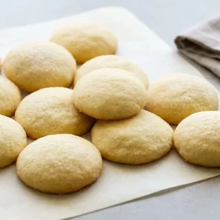 Keto sugar cookies recipe cutouts baked to a light golden edge with a delicate granulated sweetener crust
