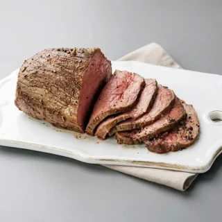 Keto roast beef recipe carved into tender, juicy slices with a savory seasoned crust.