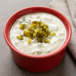 Creamy keto tartar sauce recipe served in a bowl, showcasing finely diced dill pickles and a glossy mayonnaise texture.